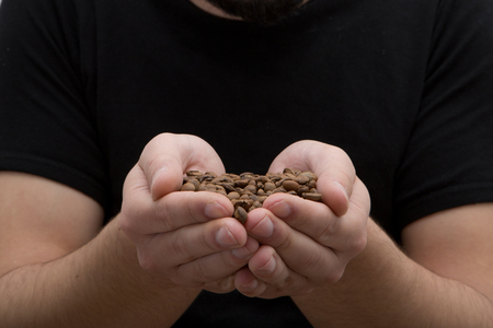 hands holding coffee making heart form isolated on white backgroundの写真素材