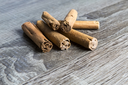 Cinnamon sticks isolated on brown wooden backgroundの写真素材