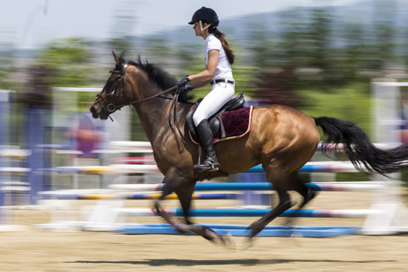 Thessloniki, Greece, June 14, 2015: Unknown rider on a horse during competition matches riding round obstaclesのeditorial素材