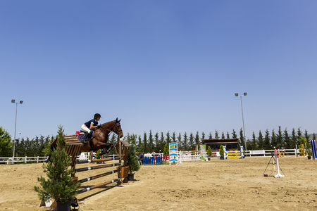 Thessloniki, Greece, June 14, 2015: Unknown rider on a horse during competition matches riding round obstaclesのeditorial素材