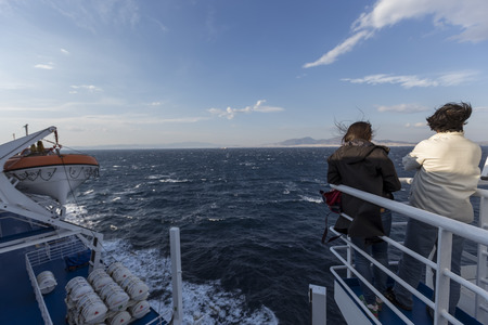 Santorini, Grece- May 12, 2015: Tourists on the deck of a ship heading to Santorini island, in Greece.のeditorial素材