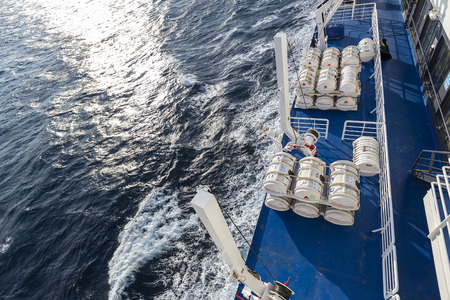 Santorini, Grece- May 12, 2015: Barrels containing emergency liferafts on the ship, in Greece. RFD...
