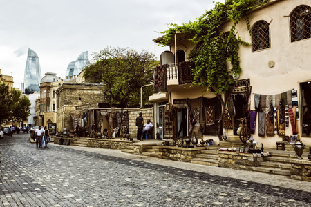Azerbaijan, Baku - September 16, 2015: Icheri Sheher (Old Town) and the Flame Towers of Baku, Azerbaijan. Typical tourist shop with souvenirs and antiques.のeditorial素材