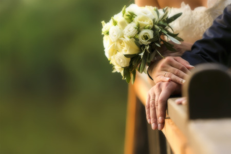 Bride and groom's hands with wedding rings (soft focus), filter colored picture style.Cross processed image for vintage lookの写真素材
