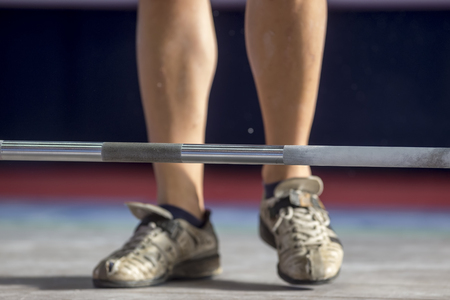 Thessaloniki, Greece, October 3, 2015: Hands and feet athlete on the barbell. Young athlete preparing to lift weights during the Greek Weightlifting Championshipのeditorial素材