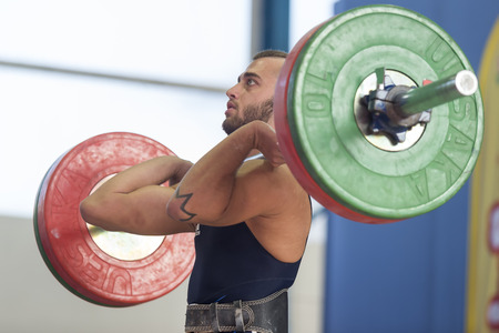 Thessaloniki, Greece, Oct 2 2015: Unknown athlete in his attempt to lift the weights during the course of the Greek Weightlifting Championshipのeditorial素材