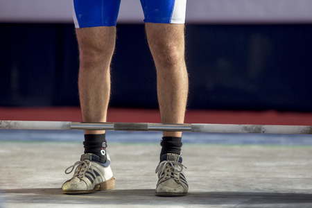 Thessaloniki, Greece, October 3, 2015: Hands and feet athlete on the barbell. Young athlete preparing to lift weights during the Greek Weightlifting Championshipのeditorial素材