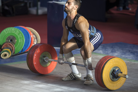Thessaloniki, Greece, Oct 2 2015: Unknown athlete in his attempt to lift the weights during the course of the Greek Weightlifting Championshipのeditorial素材