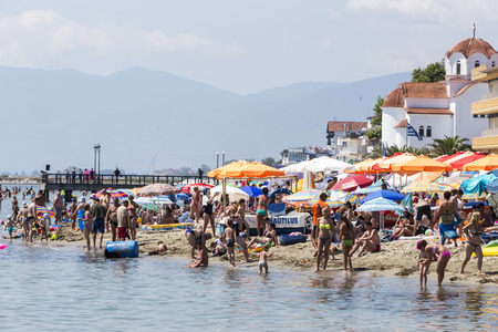 Katerini, Greece- July 7, 2015: View of the beach of Katerini in Greece. People enjoy the freshness of the ocean at a hot summer day.のeditorial素材