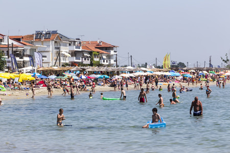 Katerini, Greece- July 7, 2015: View of the beach of Katerini in Greece. People enjoy the freshness of the ocean at a hot summer day.のeditorial素材
