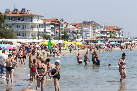 Katerini, Greece- July 7, 2015: View of the beach of Katerini in Greece. People enjoy the freshness of the ocean at a hot summer day.のeditorial素材