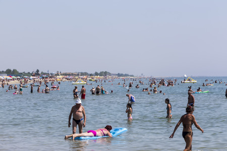 Katerini, Greece- July 7, 2015: View of the beach of Katerini in Greece. People enjoy the freshness of the ocean at a hot summer day.のeditorial素材