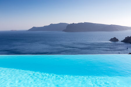 Infinity pool on the rooftop with the ocean in Santorini Island, Greeceの写真素材