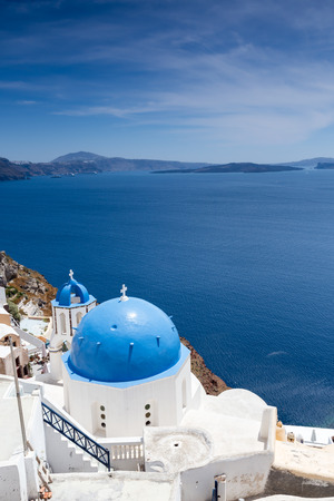 Blue domed churches on the Caldera at Oia on the Greek Island of Santorini.の写真素材