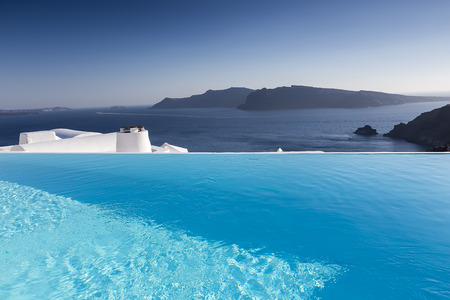 Luxury resort swimming pool in Santorini, Greeceの写真素材