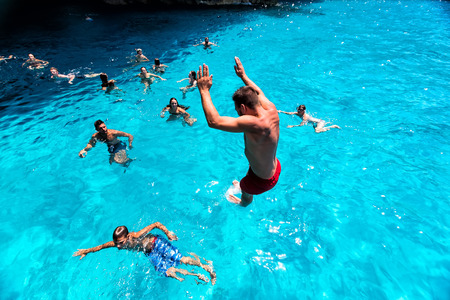 Zakynthos, Greece - August 11, 2015: Tourists enjoying the clear water of Zakynthos island, in Greece. Navagio Beach is a popular attraction among tourists visiting the island of Zakynthosのeditorial素材