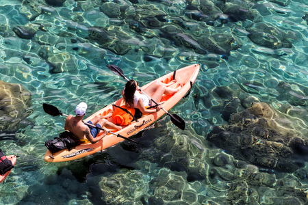 Milos, Greece - September 10, 2015: Tourists kayaking at Tsigrado Beach in Milos island, Cyclades, Greeceのeditorial素材