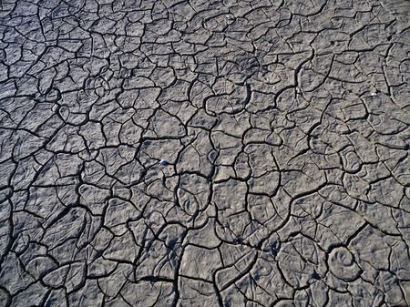 Dry lake bed with natural texture of cracked clay in perspective floor. Death Valley field ....