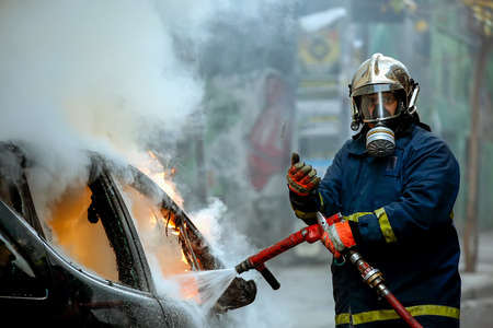 Athens, Greece - February 4, 2016: Firemen fighting a flaming car after an explosionのeditorial素材