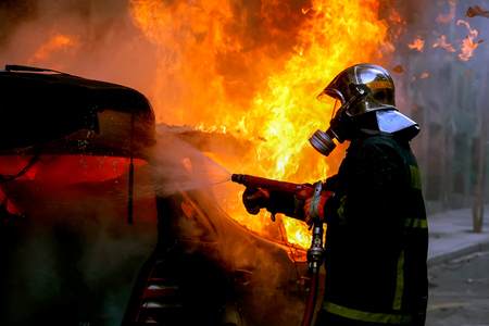 Athens, Greece - February 4, 2016: Firemen fighting a flaming car after an explosionのeditorial素材