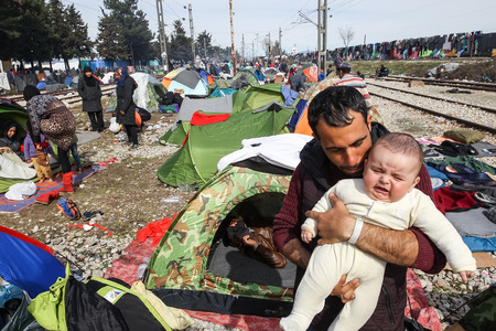 Idomeni, Greece - March 8, 2016: Thousands of immigrants are in a wait at the border between Greece and FYROM waiting to cross the borders to FYR of Macedonia.のeditorial素材