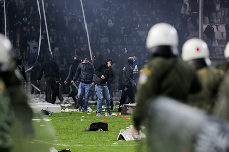 Thessaloniki, Greece - March 02, 2016: PAOK fans clash with riot police during the semifinal Greek...