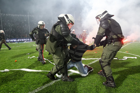 Thessaloniki, Greece - March 02, 2016: PAOK fans getting arrested after clashing with riot police during the semifinal Greek Cup game between PAOK and Olympiacos played at Toumba stadiumのeditorial素材