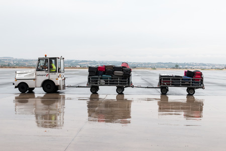 Thessaloniki, Greece - June 18, 2015: luggage cart on the runway of the airport Macedonia a rainy dayのeditorial素材