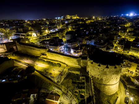 Thessaloniki, Greece - January 11, 2016: Aerial view of old Byzantine castle and the city of Thessaloniki at night, Greece. Image taken with action drone camera causing distortion and blur.のeditorial素材
