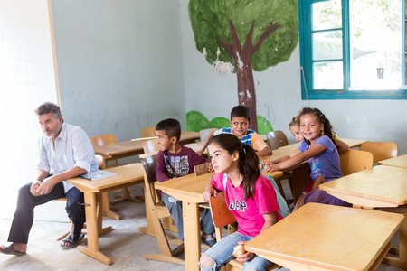 Lagadikia, Greece - August 25, 2016: Children sit in a classroom in the refugee camp of Lagadikia, some 40km North of Thessaloniki, during the visit of UN high commissioner for refugees Filippo Grandiのeditorial素材