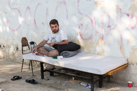 Lagadikia, Greece - August 25, 2016: A man looks on as he sits in the refugee camp of Lagadikia, some 40km North of Thessaloniki, during the visit of UN high commissioner for refugees Filippo Grandiのeditorial素材