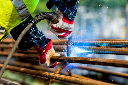 Close up of the hands welder worker with electrode. selective focus