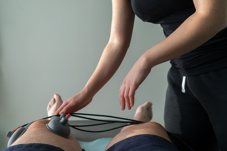 suction cups applied to a knee in physiotherapyの写真素材