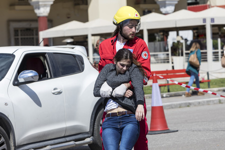Thessaloniki , Greece - April 9, 2017: First aid, victim liberation in an car accident and helmet removal demonstration by the Hellenic Red Cross rescue teamのeditorial素材