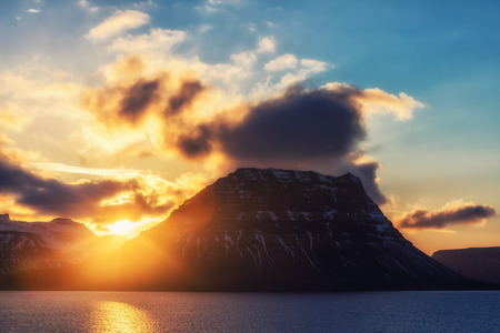 Sunset behind the famous mountain Kirkjufell in Icelandの写真素材