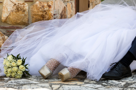 feet of bride and groom, wedding shoesの写真素材