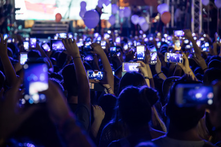 Thessaloniki , Greece - Sept 17 , 2017: People taking photographs with touch smart phone during a music concert live on stage for the Saikis Rouvas consert in Thessaloniki.のeditorial素材