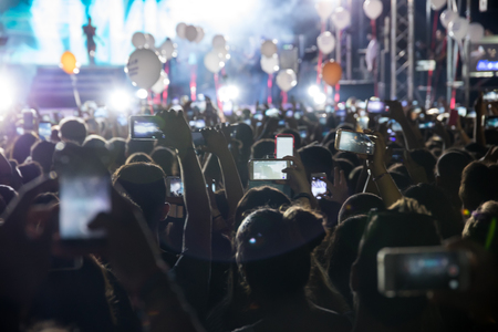 Thessaloniki , Greece - Sept 17 , 2017: People taking photographs with touch smart phone during a music concert live on stage for the Saikis Rouvas consert in Thessaloniki.のeditorial素材