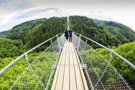 aerial view Germany's longest rope suspension bridge 300 feet above a canyon floor Geierley. It is...