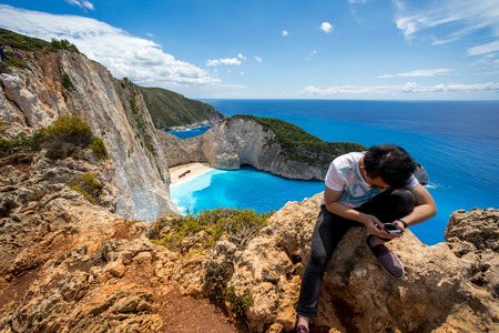 Zakynthos, Greece - July 17, 2017: Travelers on the Background Incredible Navagio (Shipwreck) Beach in Zakynthos island, Greece. Navagio Beach is a popular attraction among tourists visiting the island of Zakynthosのeditorial素材