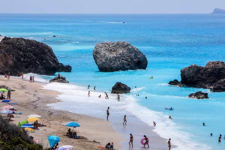 Megali Petra Lefkada, Greece - July 15, 2017: People swim in the sea at the Megali Petra Beach in Lefkada Island, Greeceのeditorial素材