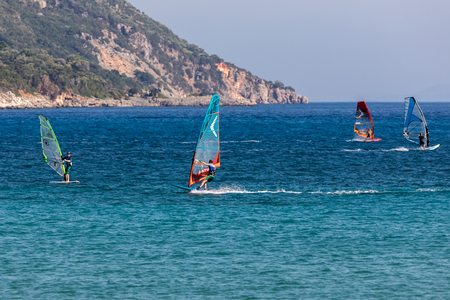 Vasiliki Lefkada, Greece - July 14, 2017: Windsurfers sailing across the Vasiliki Beach in Lefkada Island, Greeceのeditorial素材
