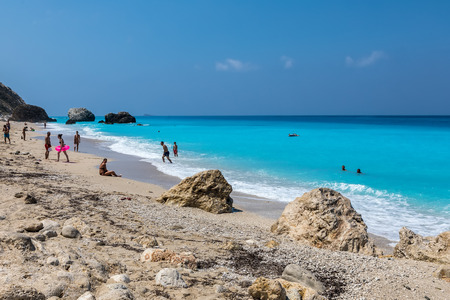 Megali Petra Lefkada, Greece - July 15, 2017: People swim in the sea at the Megali Petra Beach in Lefkada Island, Greeceのeditorial素材