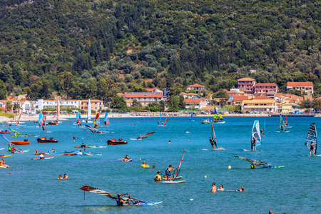 Vasiliki Lefkada, Greece - July 15, 2017: Windsurfers sailing across the Vasiliki Beach in Lefkada Island, Greeceのeditorial素材
