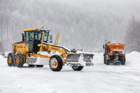 Naousa, Greece - January 13, 2018: Snow-removing machine cleans the street from the snow in the Ski...