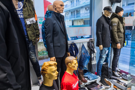 Thessaloniki, Greece - January 19, 2018: Clothes at window showcase to clothing department in the center of Thessaloniki in view of winter discounts.のeditorial素材