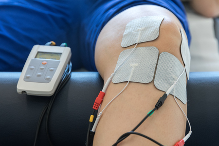 electronic therapy on knee used to treat pain. selective focusの写真素材