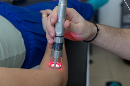 Laser therapy in hand used to treat pain. selective focusの写真素材
