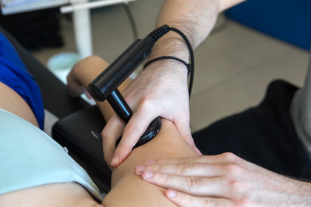 Physiotherapist doing Tecar therapy (Radio Frequency Transporter) alterantive treatment on a woman patientの写真素材