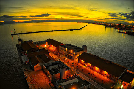 explosion of colors from the sunset above the harbor in the city of Thessaloniki, Greeceの写真素材